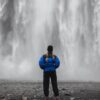 a person standing in front of a waterfall