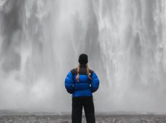 a person standing in front of a waterfall