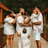 man in white dress shirt carrying baby in white dress